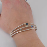 Faceted topaz gemstones in sterling silver cuff bracelet  worn on wrist