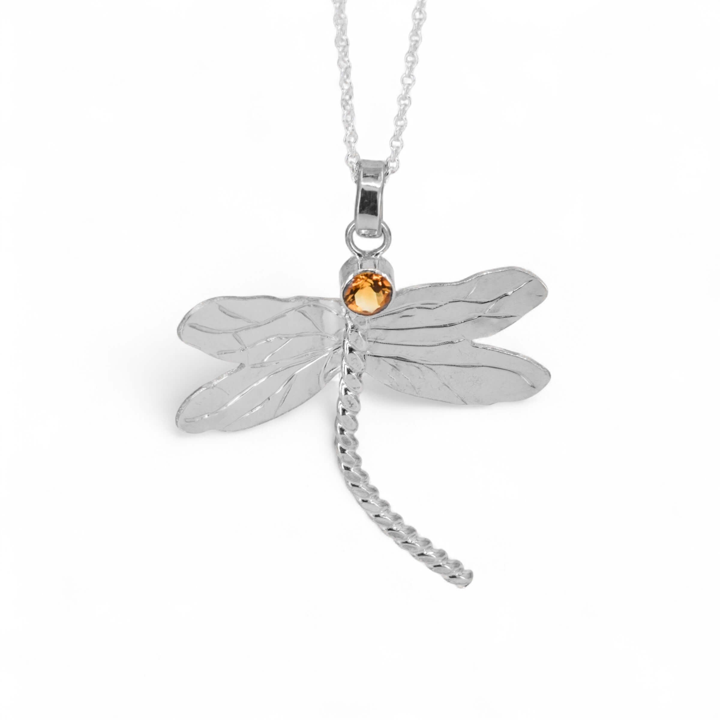 Silver dragonfly pendant necklace with a small citrine gemstone on a white background