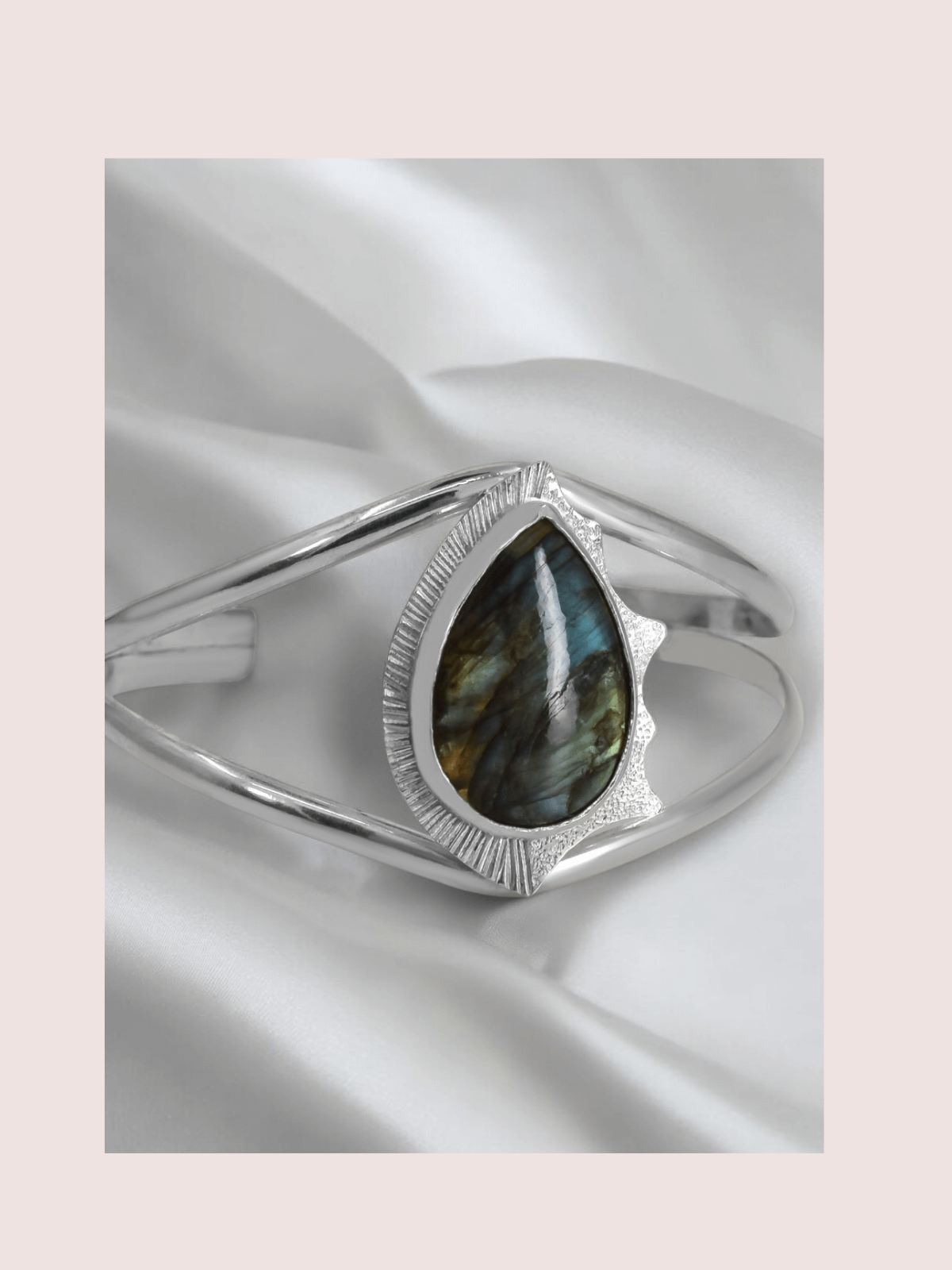 A sterling silver cuff bracelet featuring a labradorite and intricate texture 
