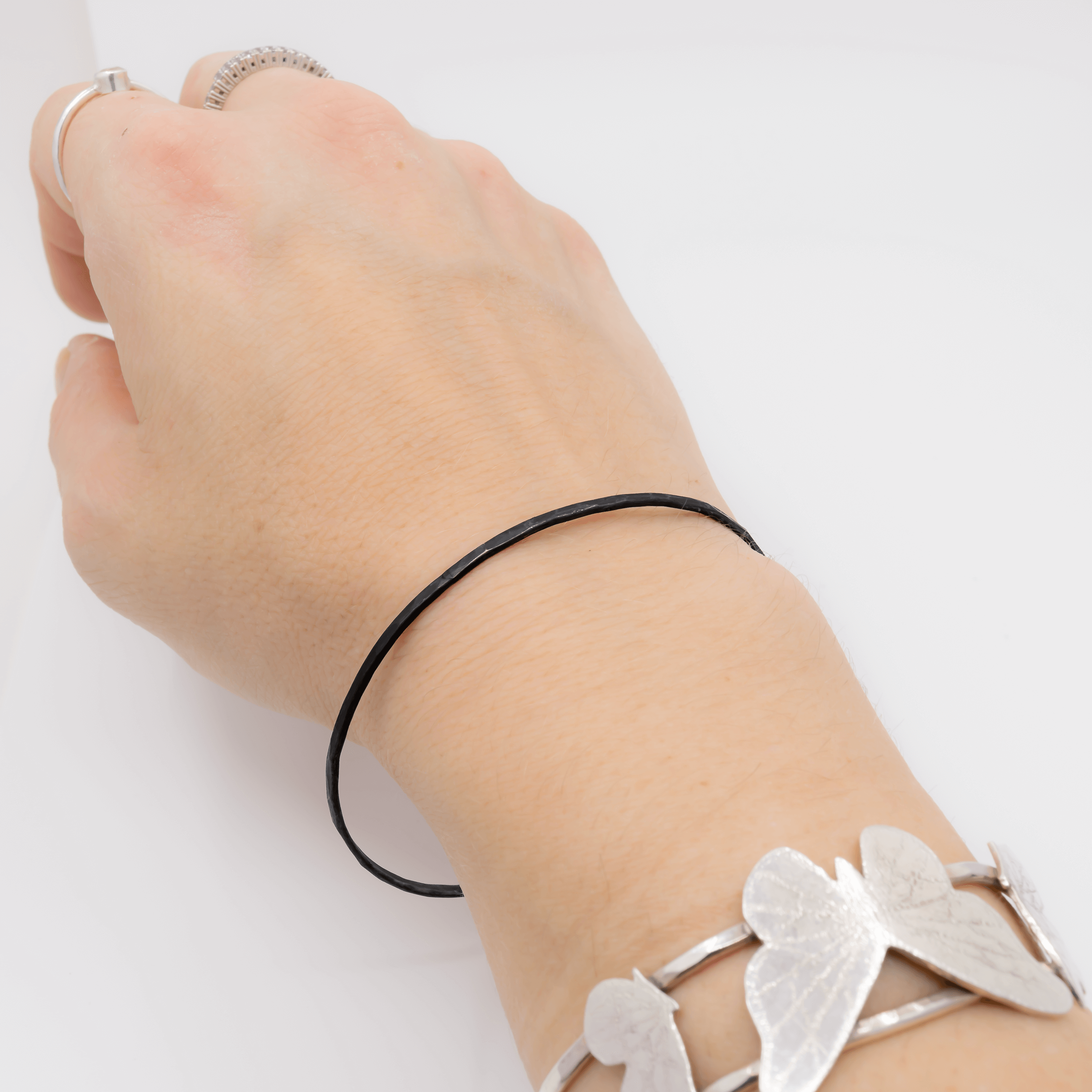 the original closed oxidized sterling silver bangle bracelet worn on wrist
