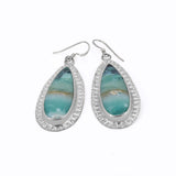 Teardrop shaped petrified wood opal dangle earrings in sterling silver  with a hand textured border around the stones.