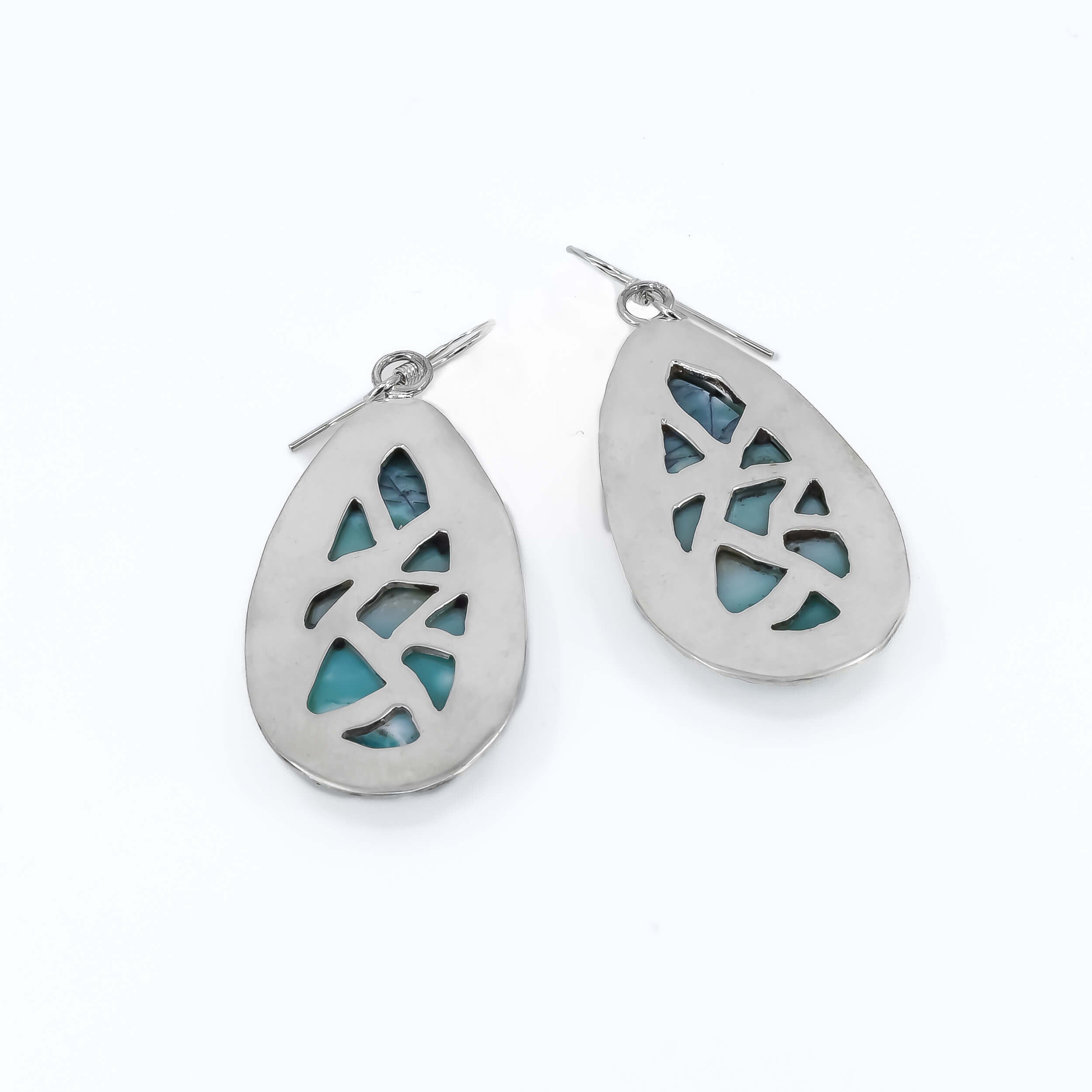 Back view of a pair of teardrop shaped petrified wood opal dangle earrings in sterling silver  with a hand textured border around the stones.