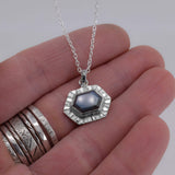Sterling Silver Evil Eye Labradorite Pendant shown for scale