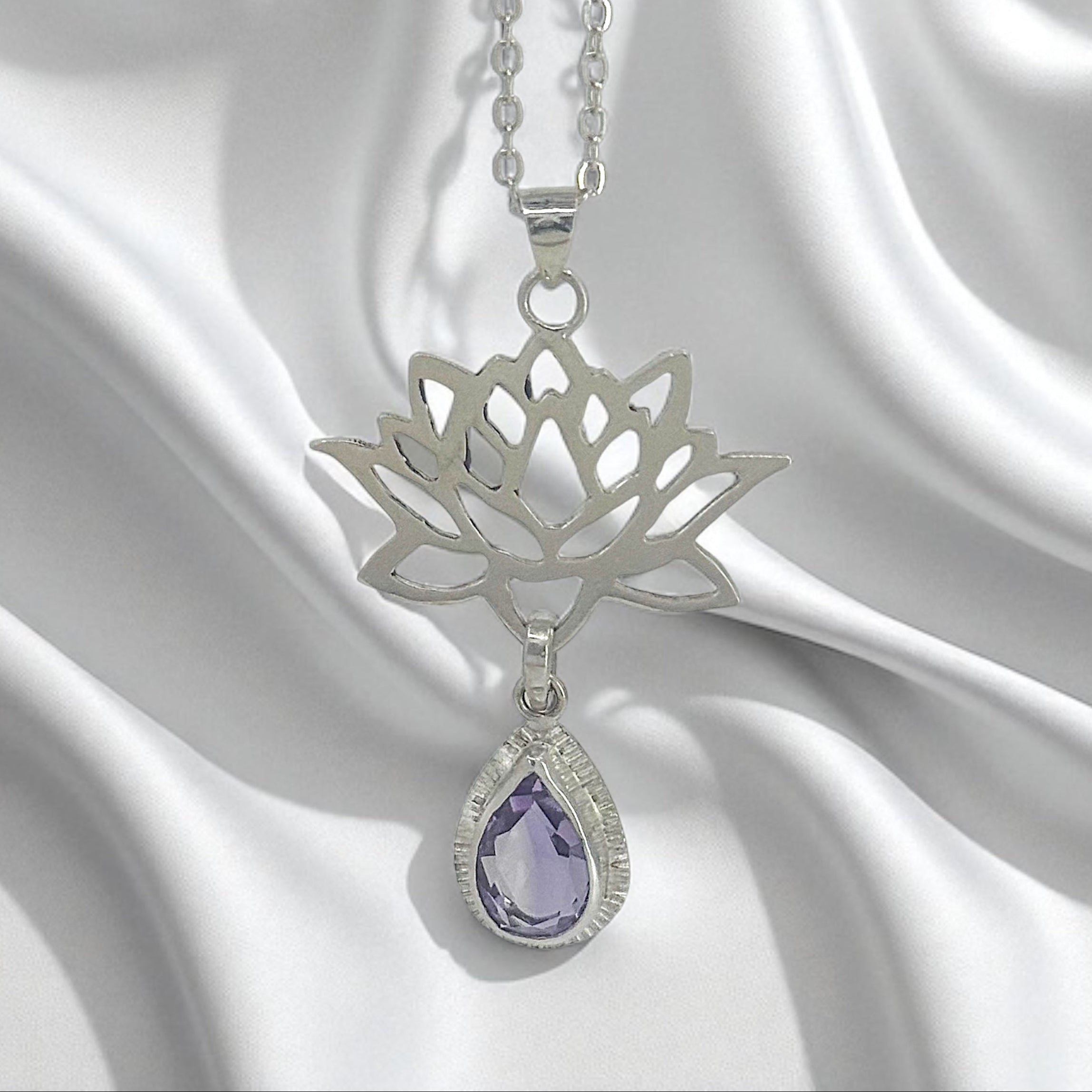 Sterling Silver Lotus Flower Pendant with Amethyst Gemstone on a satin background