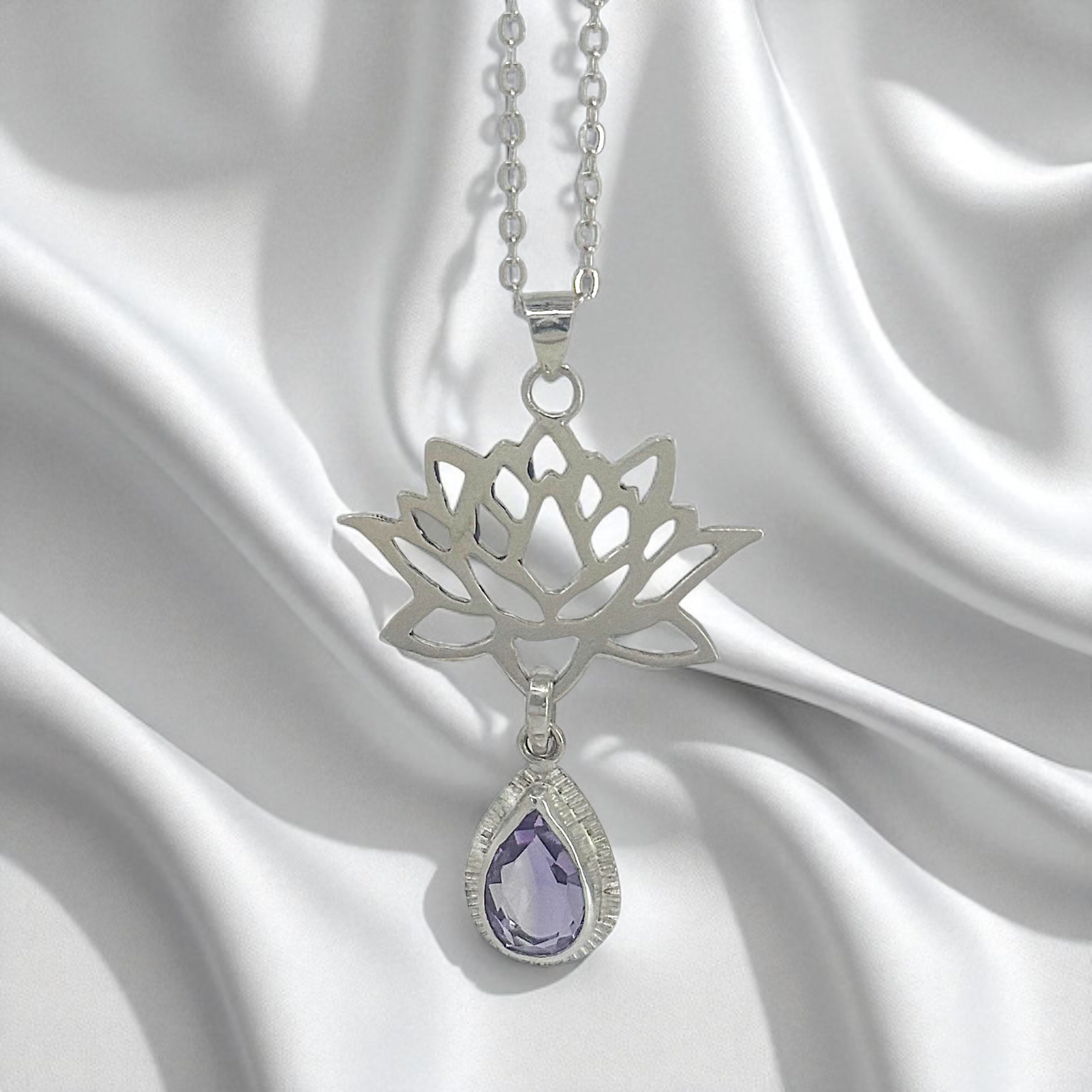 Sterling Silver Lotus Flower Pendant with Amethyst Gemstone on a satin background