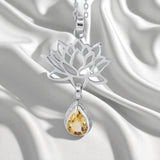 Sterling Silver Lotus Flower Pendant with Citrine Gemstone on a satin background