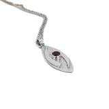 large hugged pendant necklace in sterling silver with a stardust texture and a 5mm Rhodolite garnet faceted stone