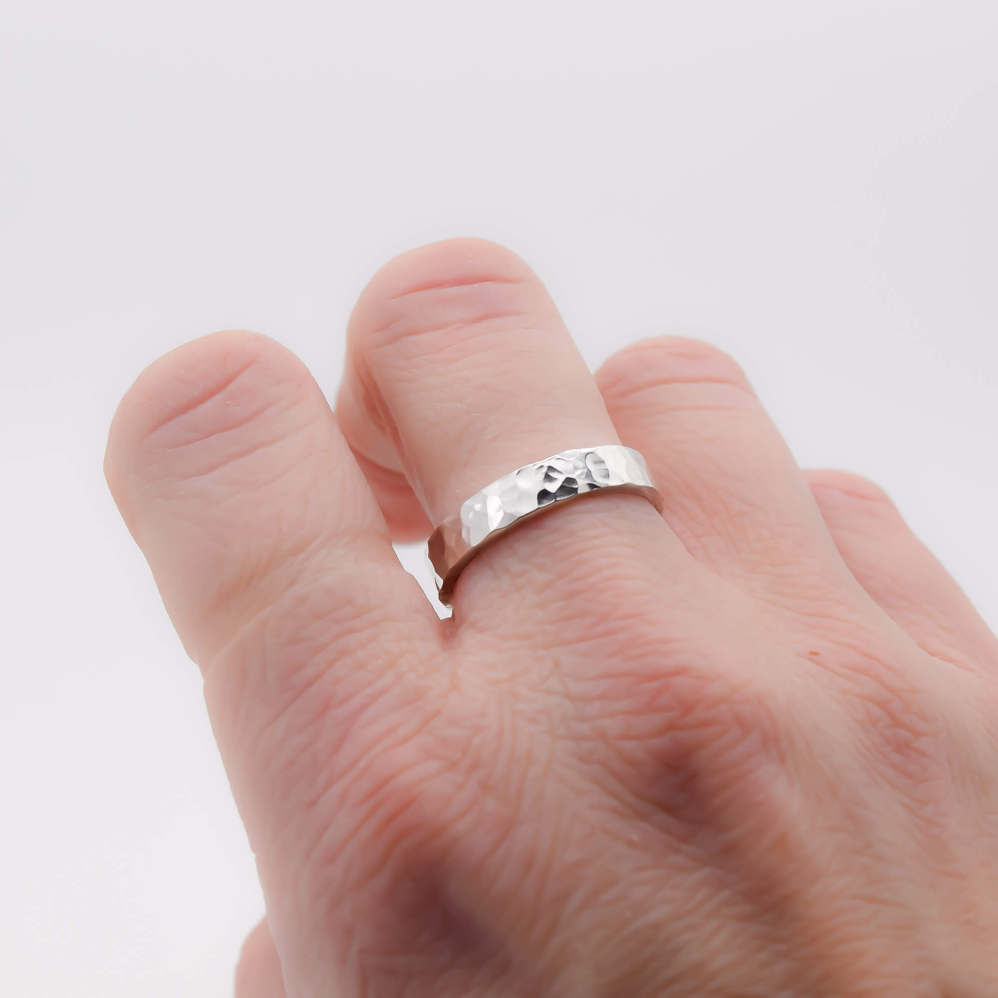 Hammered 4mm sterling silver ring band worn on hand